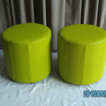 Barrel ottomans in green leather